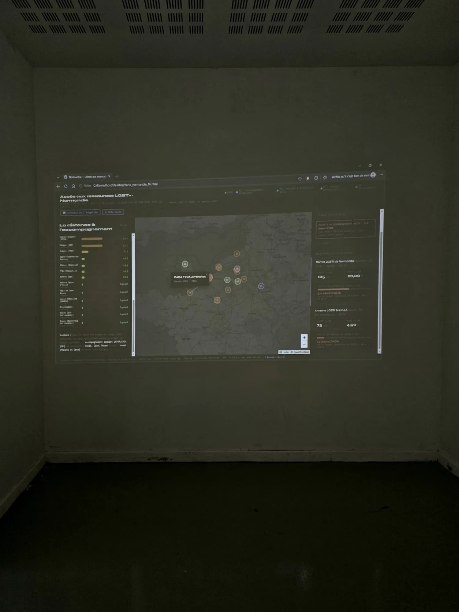 The interactive map projected on the wall of a darkened room