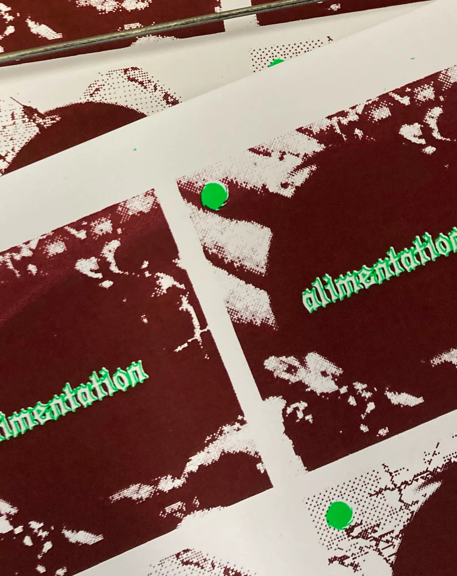 Close-up of burgundy prints bearing the word “alimentation” in fluorescent green